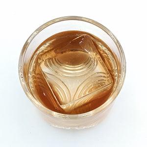 Hand-blown OnTheRocks glass tumblers with a large clear ice cube made from the OnTheRocks IceBox