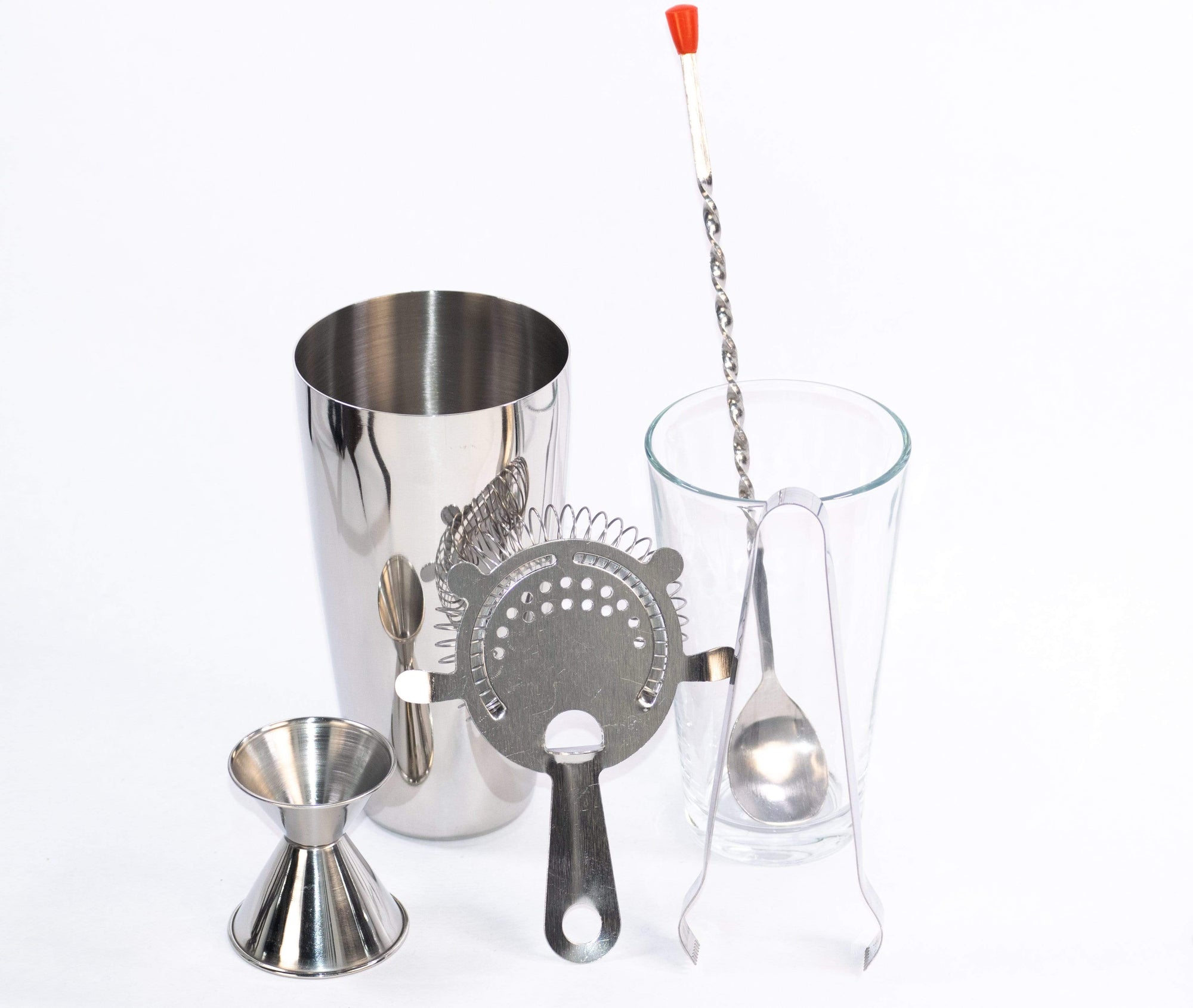 Minimalist cocktail kit featuring strainer, cocktail spoon, jigger, shaker, and ice tongs including everything you need to make all your favorite cocktails at home